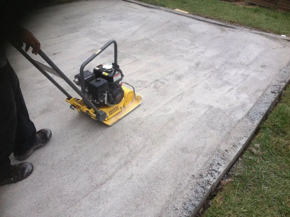 Plate compactor on a prepared patio base