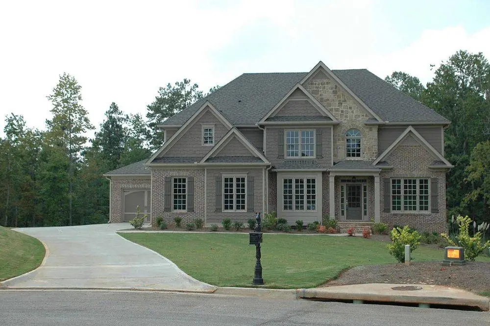 Landscaped home with a sweeping driveway and established trees